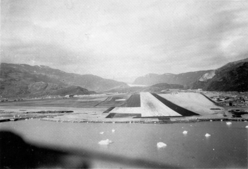 Photo: Pilot's view of the sloping runway at BW1; note the 'ice cubes' in the fjord!